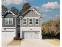 Charming two-story townhome with a brick facade, double garage doors, and well-manicured lawn at 2690 Ne Almand Ln, Conyers, GA 30013