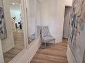 Inviting hallway featuring wood floors, elegant mirrors, and stylish decor creating a welcoming entrance at 2690 Ne Almand Ln, Conyers, GA 30013