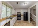 Functional kitchen with tile flooring, a full appliance suite, and ample natural light at 5307 Jay Nw Way, Lilburn, GA 30047