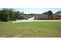 A view of the neighborhood from the side of a grassy and well-maintained lawn at 5829 Taka Ln, Lithonia, GA 30038