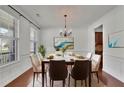 This dining room is accented by wood floors, crown moulding and an elegant light fixture at 21 Belmore Manor Dr, Suwanee, GA 30024
