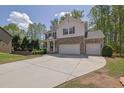 Attractive home featuring brick accents, a three-car garage, and a spacious driveway, ideal for multiple vehicles at 21 Belmore Manor Dr, Suwanee, GA 30024