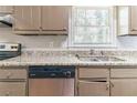 Functional kitchen showcasing countertop space, a stainless steel sink, and an open window at 6330 Phillips Pl, Lithonia, GA 30058