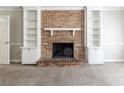 Living room features a brick fireplace with built-in shelving on both sides at 6330 Phillips Pl, Lithonia, GA 30058