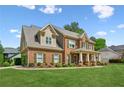 Beautiful two-story brick home with manicured lawn and lovely landscaping at 1005 Anise Ct, Dacula, GA 30019