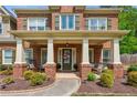 Inviting front porch with seating area, decorative wreath, and charming curb appeal at 1005 Anise Ct, Dacula, GA 30019