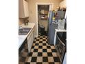 Galley kitchen with stainless steel appliances and checkerboard tile floor at 1075 Peachtree Ne Walk # 506, Atlanta, GA 30309