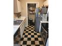 Galley kitchen featuring stainless steel appliances, tiled floor and pantry at 1075 Peachtree Ne Walk # 506, Atlanta, GA 30309