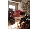 Cozy living room with a spiral staircase, a large window and a red sofa at 1075 Peachtree Ne Walk # 506, Atlanta, GA 30309