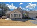 Inviting home exterior featuring a unique arched window and attached garage with paved driveway at 402 Silver Summit Se Dr, Conyers, GA 30094