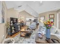 Bright living room with high ceilings, hardwood floors, and comfortable seating with dining area view at 402 Silver Summit Se Dr, Conyers, GA 30094