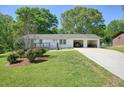 Inviting single-story home with a long driveway and an attached 2 car garage at 1214 Marshall Fuller Rd, Dallas, GA 30157