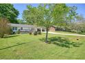 A lovely single-story home is set on a spacious lot with beautiful mature trees at 1214 Marshall Fuller Rd, Dallas, GA 30157