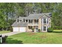 Charming two-story home featuring a welcoming front porch and well-manicured lawn at 3479 Portsmouth Cir, Lithonia, GA 30038