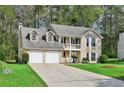 Charming two-story home featuring a welcoming front porch and well-manicured lawn at 3479 Portsmouth Cir, Lithonia, GA 30038