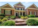 Lovely red brick home with meticulously maintained landscaping, stone walkway, and a modern Ring security system at 4862 Tarry Post Ln, Suwanee, GA 30024