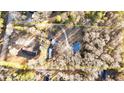 Aerial view showcasing the property, boundaries, surrounding trees, and multiple structures at 5520 Hearn Rd, Ellenwood, GA 30294