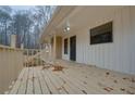 Spacious front porch with a wooden deck, providing an inviting outdoor area and entry to the home at 5520 Hearn Rd, Ellenwood, GA 30294