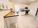 Modern kitchen features stainless steel appliances, wood countertops, and white cabinets at 4590 Galleon Xing, Decatur, GA 30035