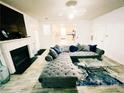 Bright living room with hardwood floors, fireplace, and large sectional sofa at 4590 Galleon Xing, Decatur, GA 30035