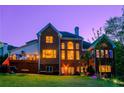 Spacious backyard featuring a brick home with large windows and a wooden deck, ideal for outdoor entertainment at 4799 Winterview Ln, Douglasville, GA 30135