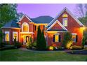 Stately brick home with meticulously landscaped front yard, including mature trees and shrubs at 4799 Winterview Ln, Douglasville, GA 30135