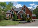 Beautiful brick home with manicured lawn and landscaping on a sunny day at 4799 Winterview Ln, Douglasville, GA 30135