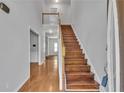 Bright foyer featuring hardwood floors, staircase to the second floor, and neutral paint at 7228 Silverleaf Cir, Fairburn, GA 30213