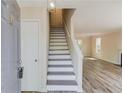Bright foyer showcasing newly installed floors and a staircase leading to the upper level at 11205 Abbotts Station Dr, Duluth, GA 30097