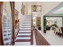 Grand foyer with staircase, high ceilings, and open floor plan offers a welcoming entry to the home at 1490 Rivershyre Pkwy, Lawrenceville, GA 30043