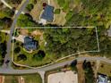 Aerial view shows the beautiful estate grounds with lush trees surrounding the home on a spacious lot at 200 Sugar Mill Ln, Canton, GA 30115