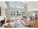 Bright living room with fireplace, hardwood floors, and large windows overlooking the back yard at 1105 Westbrooke Ne Way, Brookhaven, GA 30319