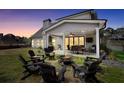 Relaxing backyard with a covered patio featuring a table and chairs, a fire pit, and outdoor seating at 220 Alcovy Reserve Way, Covington, GA 30014