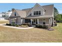 Charming two-story home with a welcoming front porch, landscaped yard, and traditional architectural style at 220 Alcovy Reserve Way, Covington, GA 30014