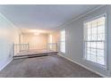 Spacious living room with plush carpeting, neutral paint, and plenty of natural light at 2352 Rockwood Way, Stone Mountain, GA 30087