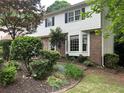 This home has lovely landscaping with large, trimmed bushes, mulch beds, and an eye-catching bay window at 3798 Lee Ridge Sw Way, Lilburn, GA 30047