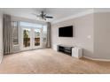 Spacious living room featuring neutral walls, a ceiling fan, a TV and access to the balcony at 400 17Th Nw St # 2125, Atlanta, GA 30363