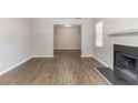 Open living room featuring neutral walls, modern hardwood floors, and a fireplace at 5439 Farmview Close, Stone Mountain, GA 30088