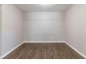 Neutral walls with updated laminate flooring in the empty bedroom at 5439 Farmview Close, Stone Mountain, GA 30088
