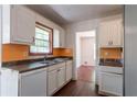 Bright kitchen featuring a window, white cabinets, and wood-look flooring at 101 Valleydale Dr, Stockbridge, GA 30281