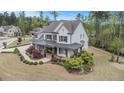 Areal view showing beautiful landscaping and covered front porch that highlights the home's charming curb appeal at 3039 Malbec Vly, Acworth, GA 30101
