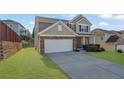 Charming two-story home with stone accents, well-manicured lawn, and a two car garage at 679 Barley Hill Ln, Sugar Hill, GA 30518
