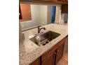 Kitchen with a granite countertop and stainless steel sink with updated faucet at 812 Seasons Pkwy, Norcross, GA 30093