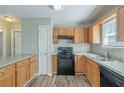 Functional kitchen with updated countertops, black appliances and durable wood flooring at 2212 Butner Sw Rd, Atlanta, GA 30331