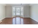 Open living room boasting hardwood floors and a large bay window for lots of natural light at 498 Haven Ridge Dr, Stockbridge, GA 30281