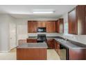 Bright kitchen offering dark wood cabinets, granite countertops and island at 5011 Wewatta Sw St, Atlanta, GA 30331