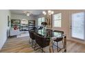 Dining area with contemporary table and chairs, wood-look flooring, and modern light fixture at 597 River Gardens Dr, Atlanta, GA 30354