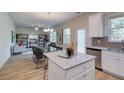 Open-concept floor plan with island featuring granite countertops, modern appliances, and wood-look flooring at 597 River Gardens Dr, Atlanta, GA 30354