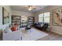 Living room with neutral walls, shelving, modern furnishings, and natural light from large windows at 597 River Gardens Dr, Atlanta, GA 30354
