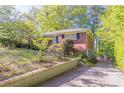 Brick house with a long driveway and landscaped yard is the perfect property for any buyer at 2345 Leith Ave, Atlanta, GA 30344